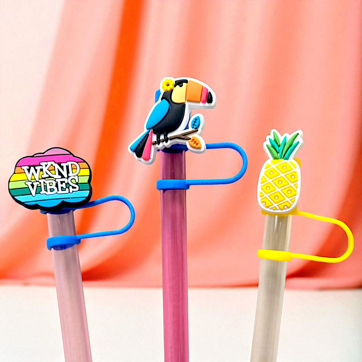 Biddlebee Three colorful straw toppers with unique designs on a pink background
