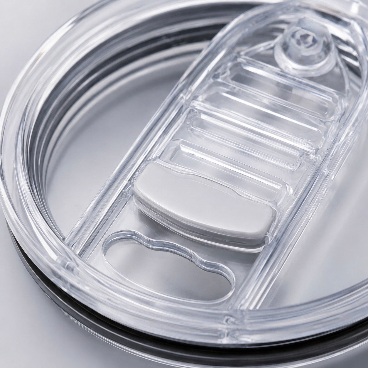 Close-up of Biddlebee Brew coffee lid showing the open sip position and locking mechanism detail