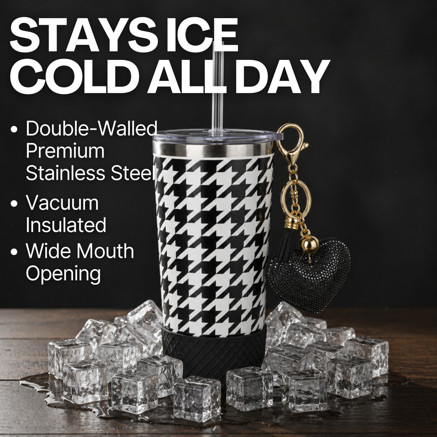 Biddlebee 20oz signature black and white charm tumbler with ice cubes and keychain on a dark background