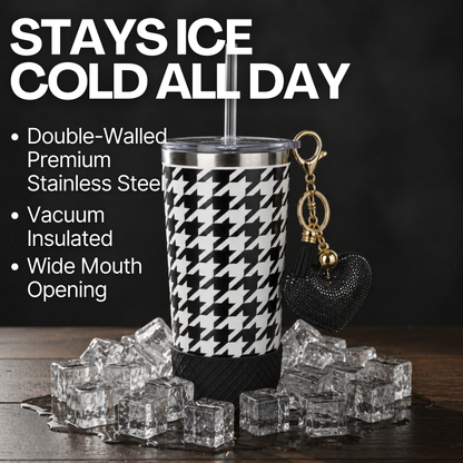 Biddlebee 20oz signature black and white charm tumbler with ice cubes and keychain on a dark background