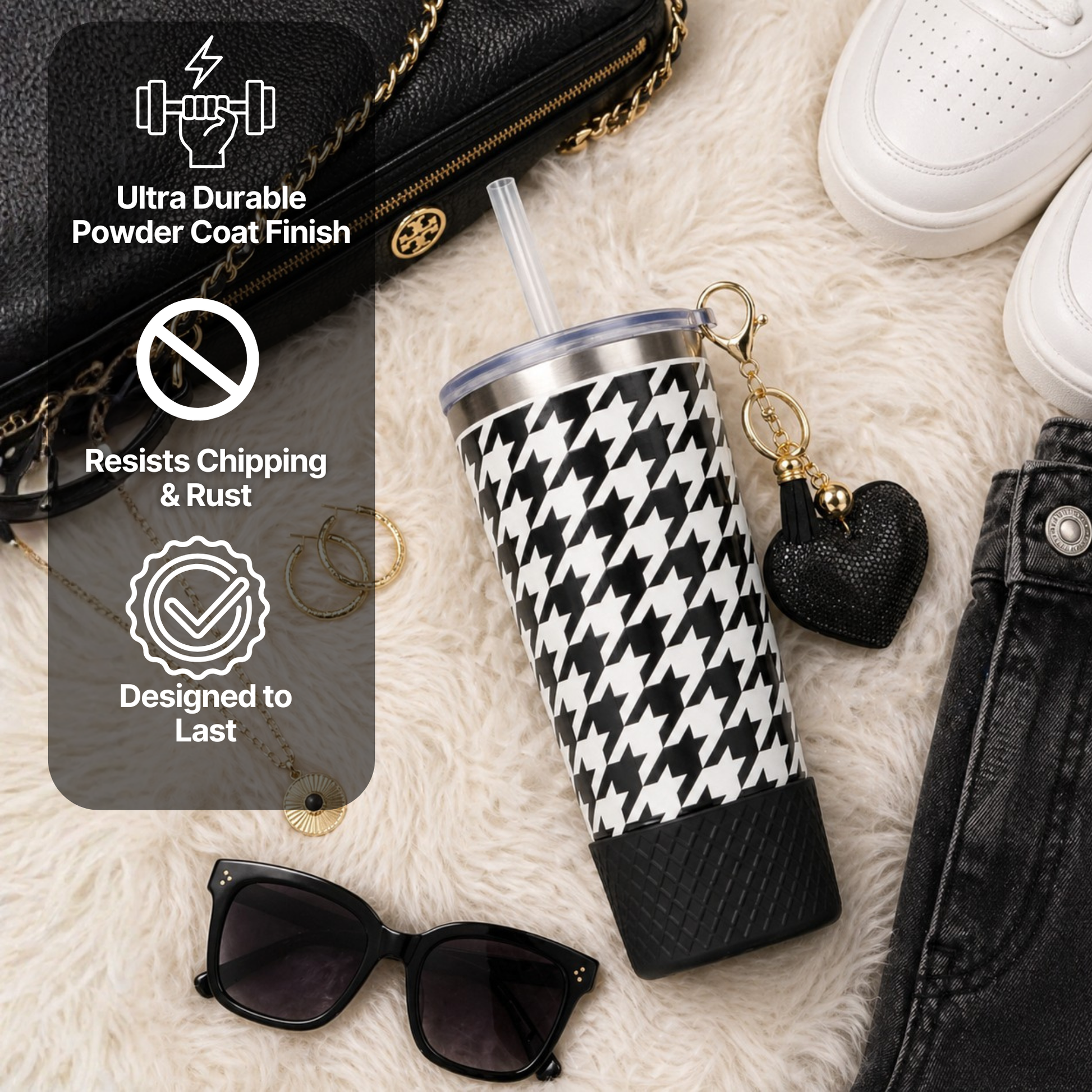Biddlebee 20oz signature black and white charm tumbler with black protective silicone boot , sunglasses, and keychain on a textured surface.