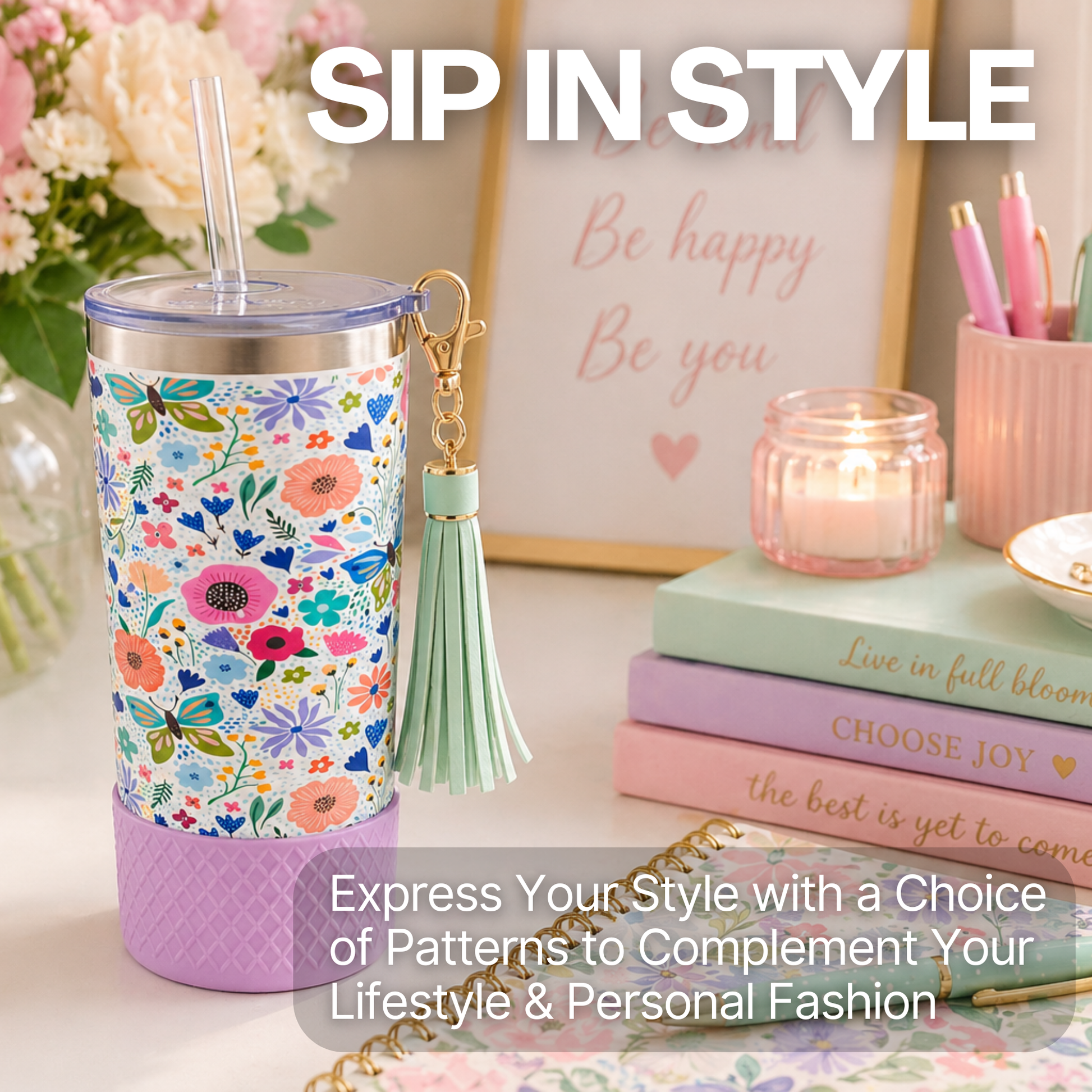 Biddlebee 20oz butterfly and Floral-patterned charm tumbler with a tassel on a table with books and decor.