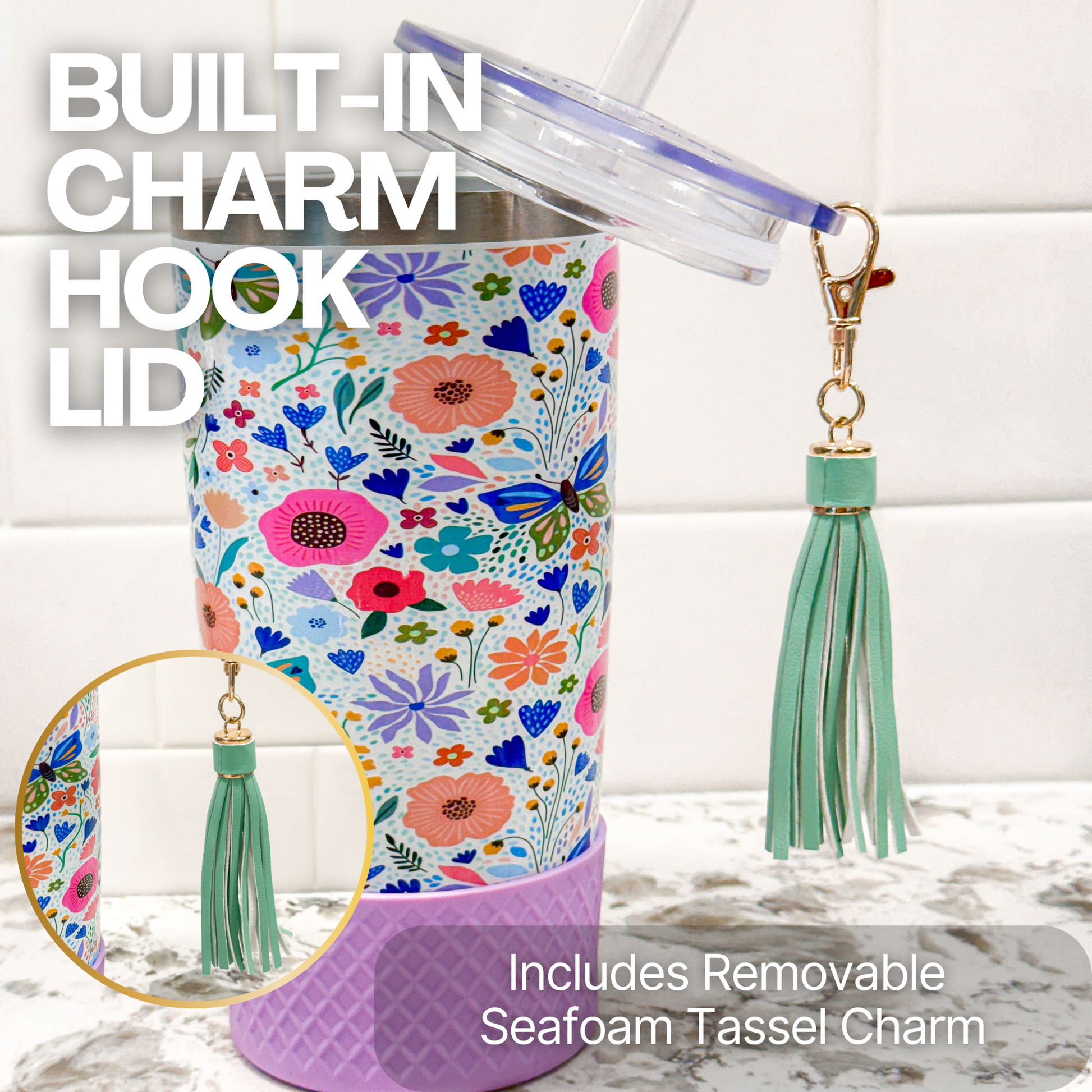 Biddlebee 20oz  butterfly and floral-patterned charm tumbler with a built-in charm hook lid and removable tassel charm on a marble surface.