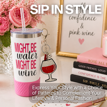 Biddlebee Pink tumbler with 'Might be water, might be wine' text and silicone boot, keychain, and books on a decorative surface.