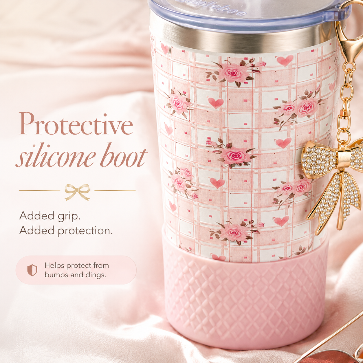 Biddlebee 20oz charm tumbler Pink cup with straw lid with floral pattern and protective silicone boot on a soft pink background