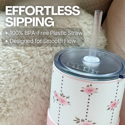 Biddlebee 30oz pink roses charm tumbler with easy sip straw lid, removable heart charm, and protective silicone boot on a fluffy beige surface, featuring text about effortless sipping and BPA-free design.