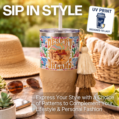 Biddlebee 30oz Desert dreams Charm tumbler with easy sip straw, boho tassel charm, and silicone boot.  Features southwestern boho print pattern with 'Desert Dreams' design on a table with sunglasses and a hat, featuring UV print technology.