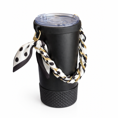 Biddlebee Brew Black coffee tumbler  with a polka dot scarf and gold chain on a white background