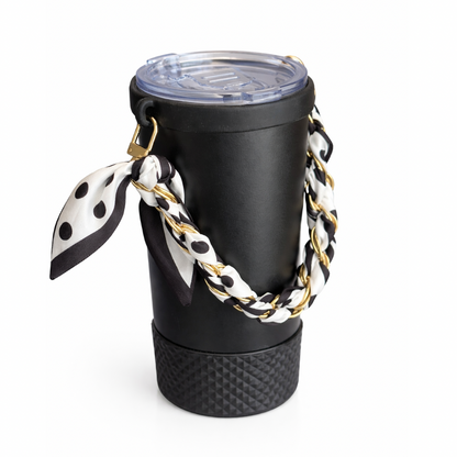 Biddlebee Brew Black coffee tumbler  with a polka dot scarf and gold chain on a white background