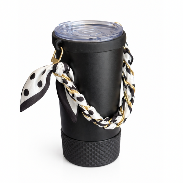 Biddlebee Brew Black coffee tumbler  with a polka dot scarf and gold chain on a white background