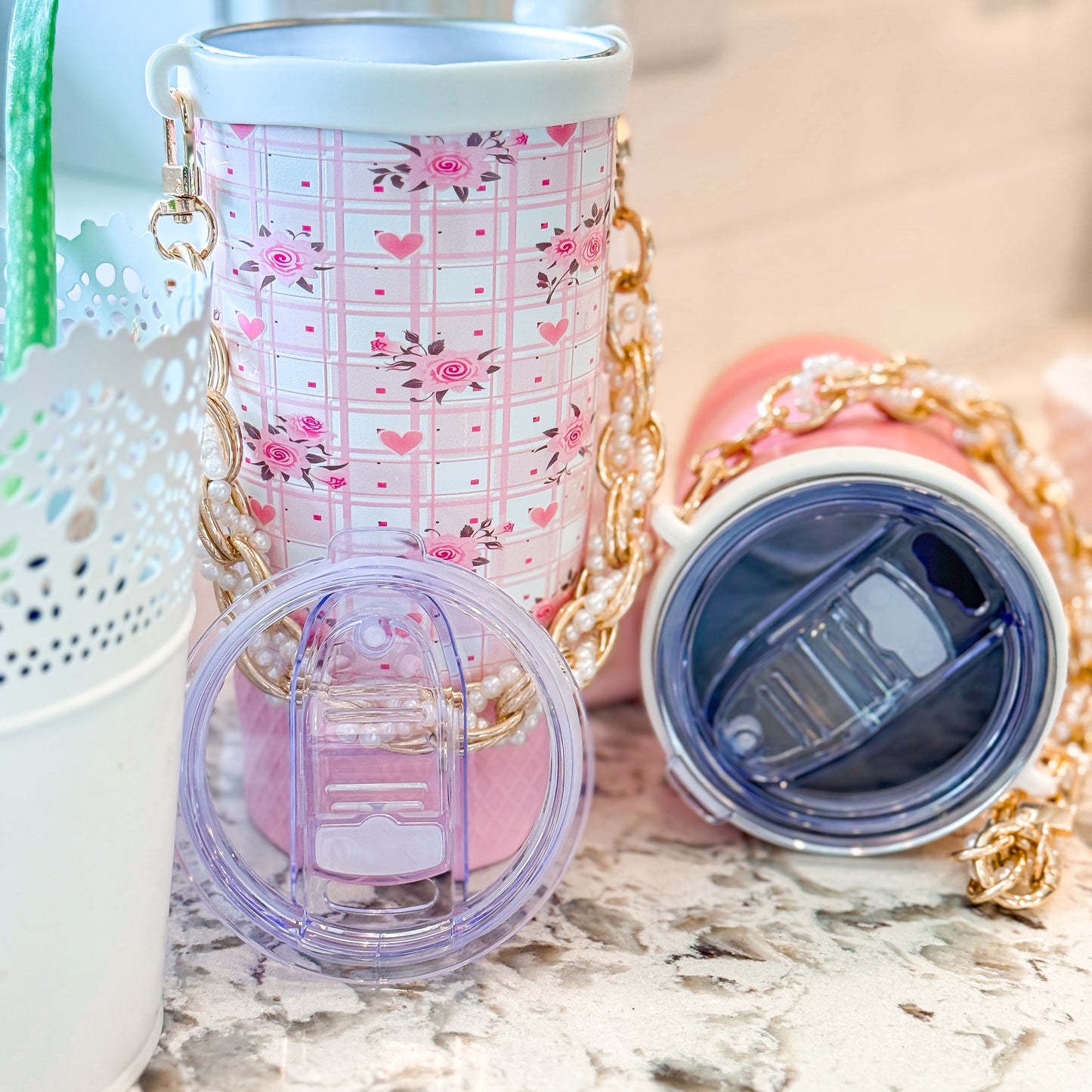 Biddlebee Brew Pink Roses Tumbler  with gold chain on a marble surface